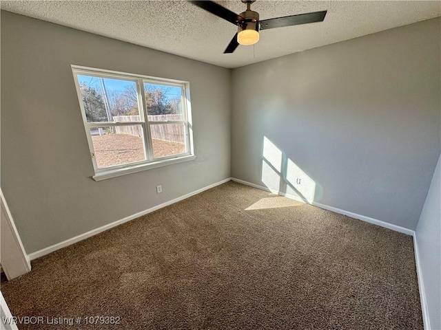 carpeted empty room with a textured ceiling, ceiling fan, and baseboards