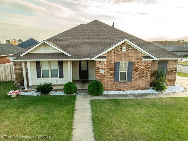 ranch-style home with a lawn