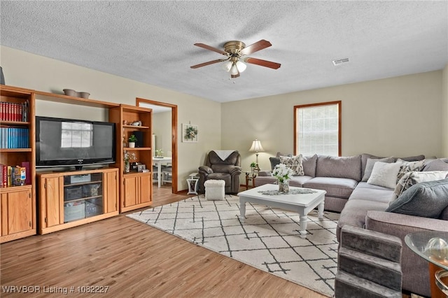 23 Wild Rose Ln, Booneville, AR 72927 - living room with wood finished floors, ceiling fan, and a textured ceiling