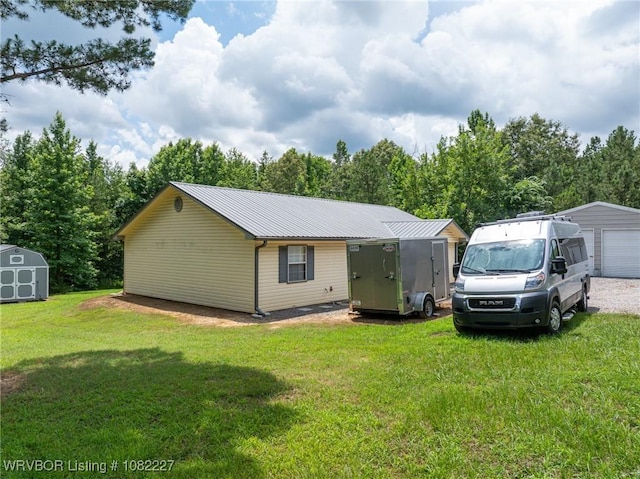 23 Wild Rose Ln, Booneville, AR 72927 - view of front of home with a storage shed, a metal roof, and a front lawn