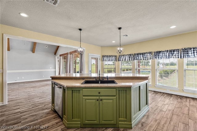 kitchen with stainless steel dishwasher, sink, a notable chandelier, hanging light fixtures, and an island with sink