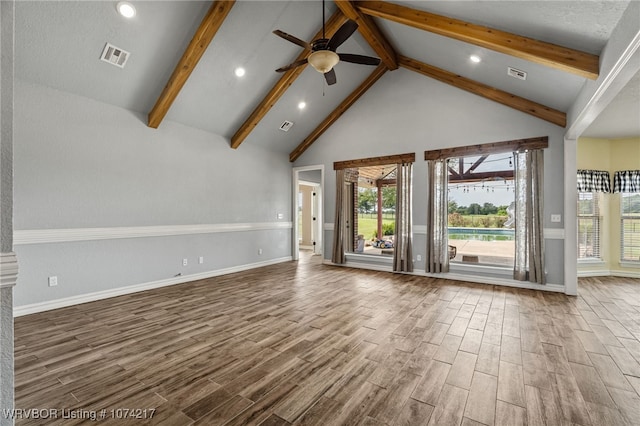 unfurnished living room with ceiling fan, beamed ceiling, and high vaulted ceiling