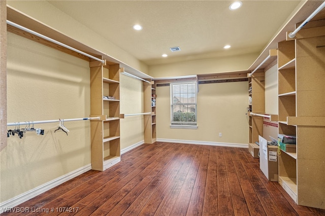 spacious closet with dark wood-type flooring