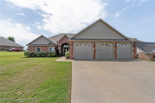 view of front of house with a garage and a front lawn