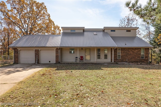 view of property featuring a front yard, a porch, and a garage