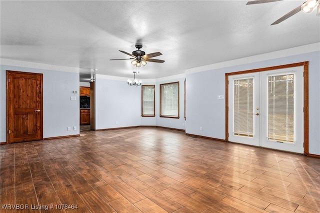 spare room with hardwood / wood-style flooring, plenty of natural light, and ceiling fan with notable chandelier