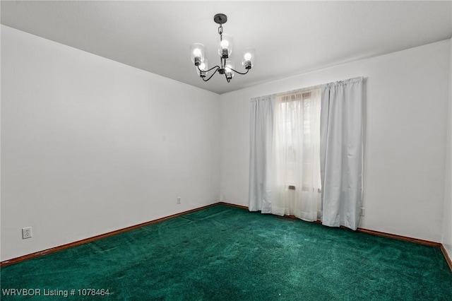 empty room with a notable chandelier and dark colored carpet