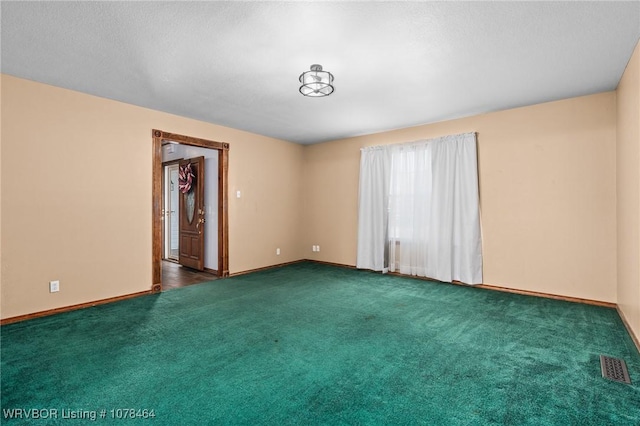 empty room featuring dark colored carpet