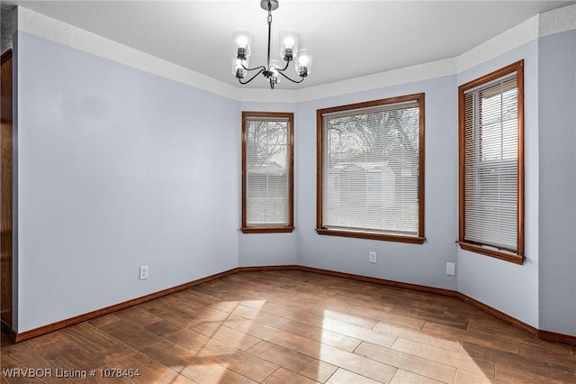 unfurnished room featuring a notable chandelier