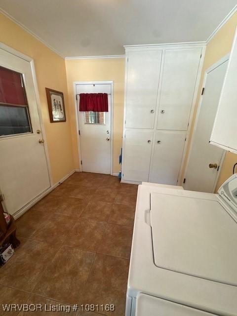 216 Jefferson Dr, Charleston, AR 72933 - washroom featuring washer / dryer, cabinet space, crown molding, tile patterned flooring, and baseboards