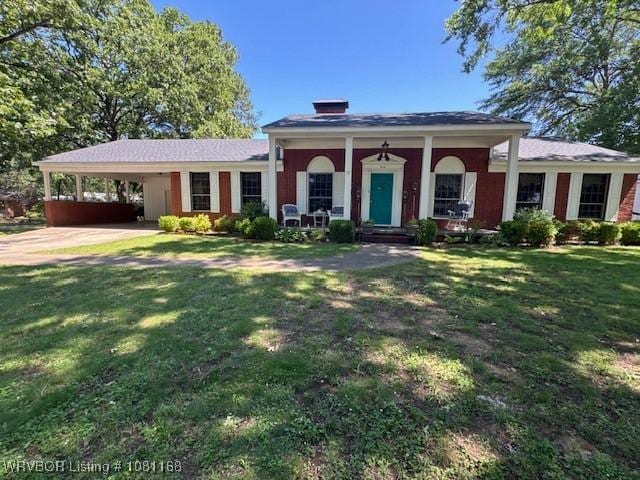 216 Jefferson Dr, Charleston, AR 72933 - view of front of home featuring a front lawn, a carport, a porch, and driveway