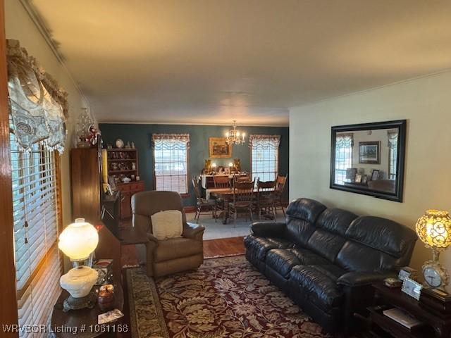 216 Jefferson Dr, Charleston, AR 72933 - living room with a chandelier, wood finished floors, and ornamental molding