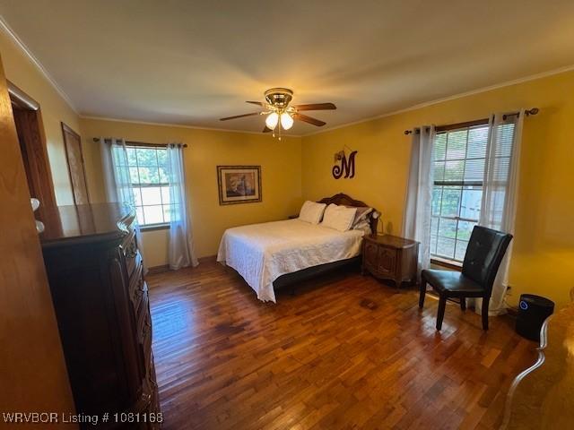 216 Jefferson Dr, Charleston, AR 72933 - bedroom featuring crown molding, wood finished floors, ceiling fan, and baseboards