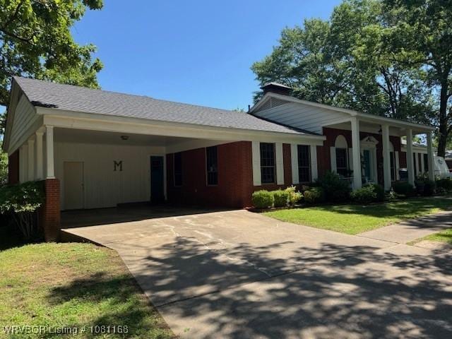 216 Jefferson Dr, Charleston, AR 72933 - view of front of home featuring driveway, an attached carport, and a front lawn