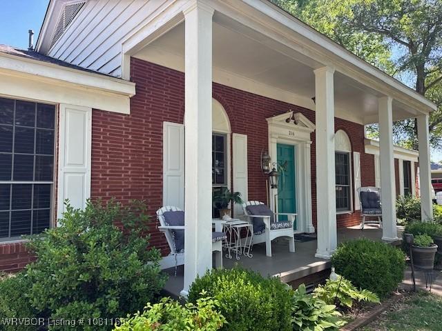 216 Jefferson Dr, Charleston, AR 72933 - entrance to property featuring a porch and brick siding