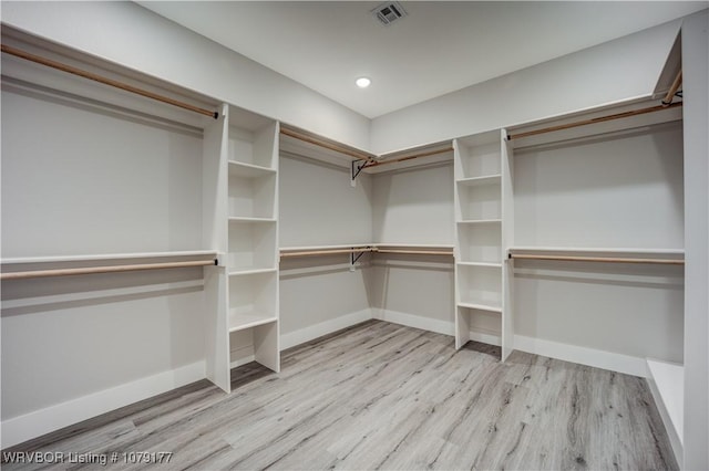 walk in closet featuring light wood-type flooring and visible vents