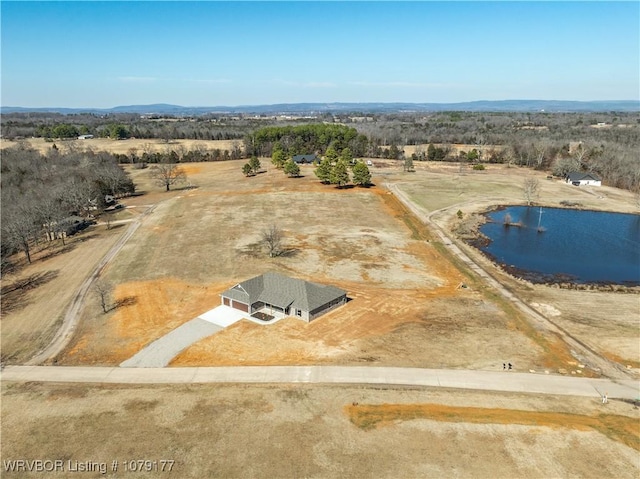 drone / aerial view featuring a rural view and a water view