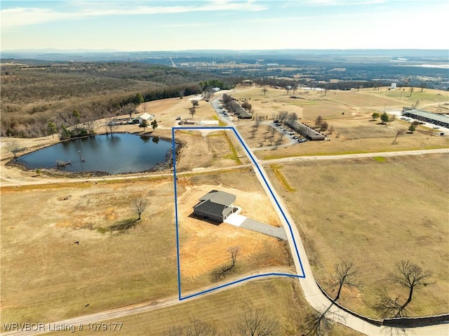 birds eye view of property featuring a water view and a rural view