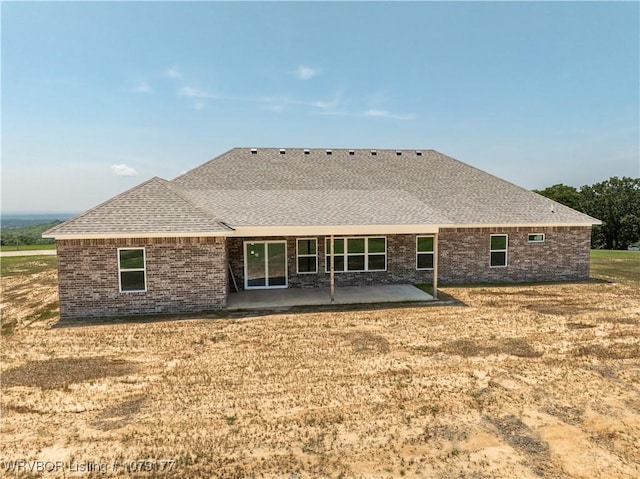 3220 Harmony Rd, Alma, AR 72921 - rear view of house with a patio, brick siding, roof with shingles, and a yard
