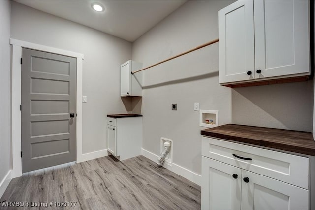 laundry area featuring light wood-style flooring, hookup for an electric dryer, washer hookup, baseboards, and cabinet space