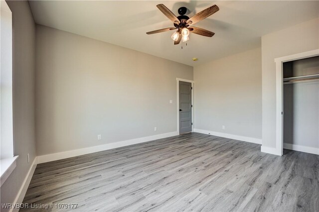 3220 Harmony Rd, Alma, AR 72921 - unfurnished bedroom with wood finished floors, a closet, and ceiling fan