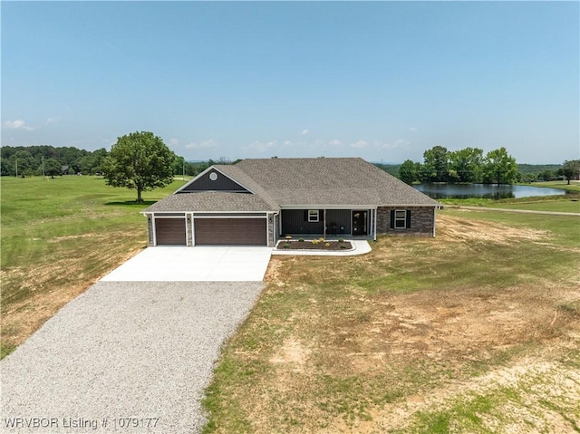 3220 Harmony Rd, Alma, AR 72921 - single story home featuring gravel driveway, an attached garage, a water view, and a front yard