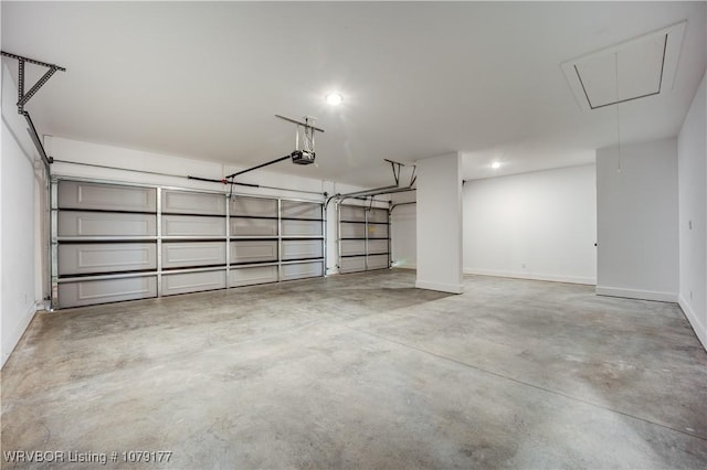 garage featuring a garage door opener and baseboards