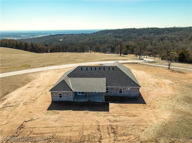 drone / aerial view featuring a rural view and a wooded view