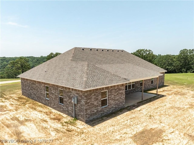 3220 Harmony Rd, Alma, AR 72921 - view of side of home featuring roof with shingles, a patio, and brick siding