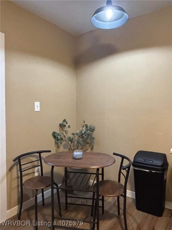 dining space with dark hardwood / wood-style flooring