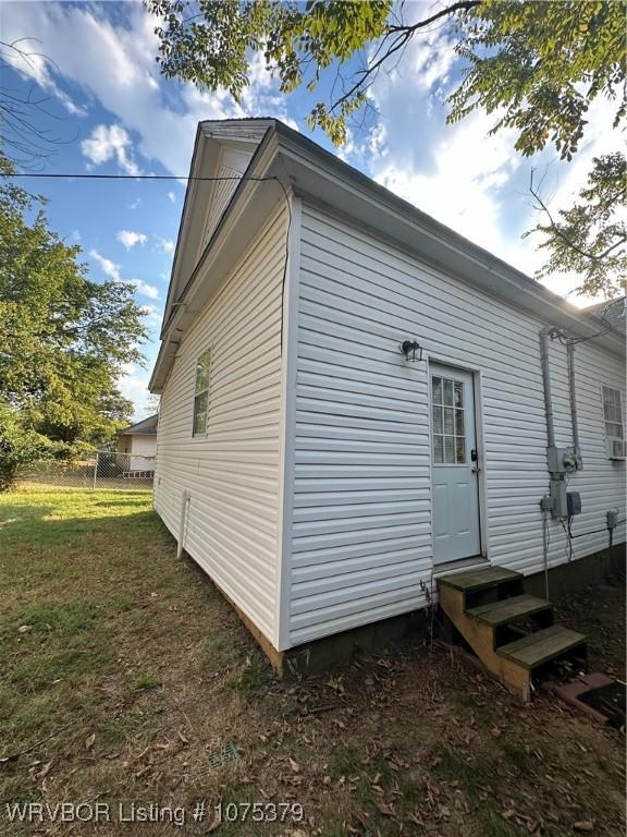 view of side of home featuring a lawn