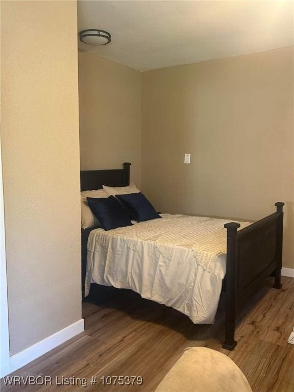 bedroom with wood-type flooring