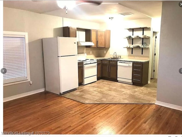 kitchen featuring light wood-type flooring, white appliances, and sink