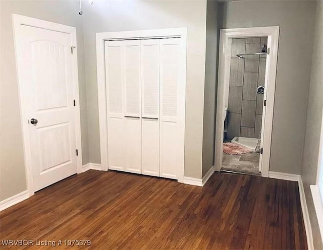 unfurnished bedroom featuring dark hardwood / wood-style floors