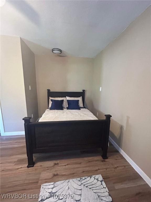 bedroom with wood-type flooring