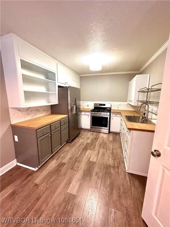 208 Cane Hill St, Van Buren, AR 72956 - kitchen featuring appliances with stainless steel finishes, wood finished floors, a textured ceiling, open shelves, and ornamental molding