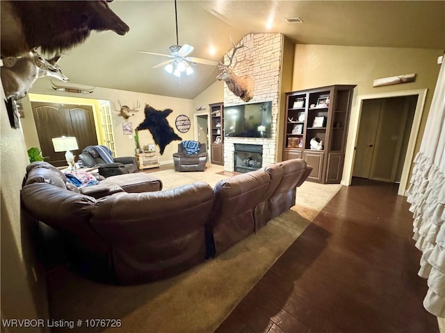 living room with a fireplace, hardwood / wood-style flooring, vaulted ceiling, and ceiling fan