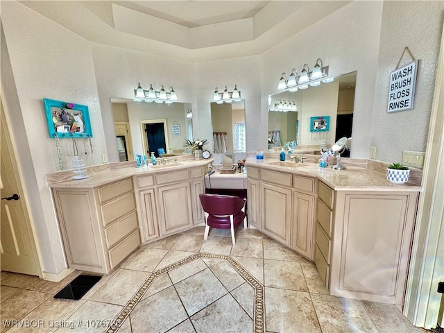 bathroom featuring tile patterned floors, vanity, and a raised ceiling