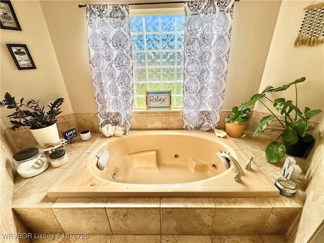 bathroom with tiled bath