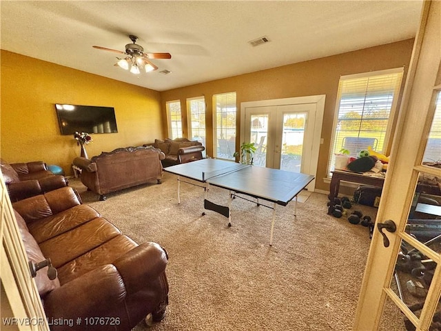 playroom featuring ceiling fan, lofted ceiling, light carpet, and french doors