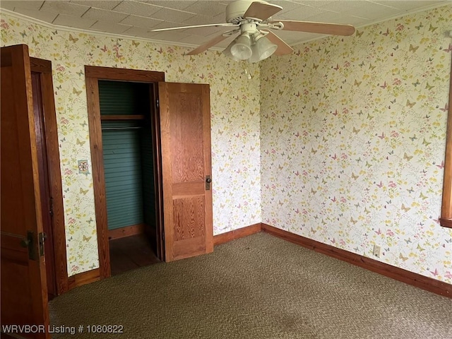 unfurnished bedroom featuring baseboards, carpet flooring, and crown molding