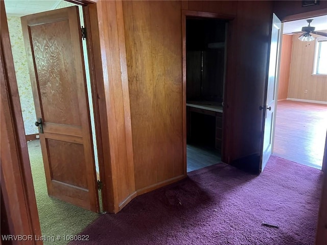 corridor with baseboards and carpet floors
