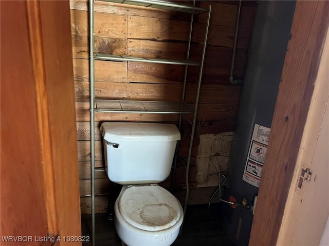 bathroom featuring water heater and toilet