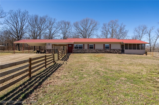 single story home with metal roof, driveway, and a sunroom