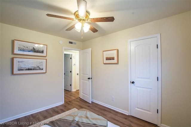 unfurnished bedroom with baseboards, visible vents, and wood finished floors