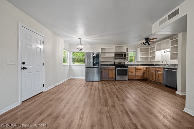 96708 S 4515, Vian, OK 74962 - kitchen with open shelves, stainless steel appliances, light wood-style flooring, and plenty of natural light