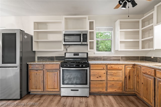96708 S 4515, Vian, OK 74962 - kitchen featuring stainless steel appliances, open shelves, a ceiling fan, wood finished floors, and brown cabinets