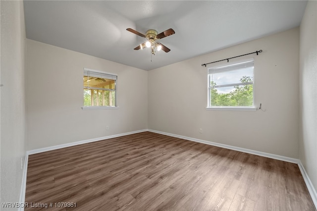 96708 S 4515, Vian, OK 74962 - empty room with healthy amount of natural light, wood finished floors, a ceiling fan, and baseboards