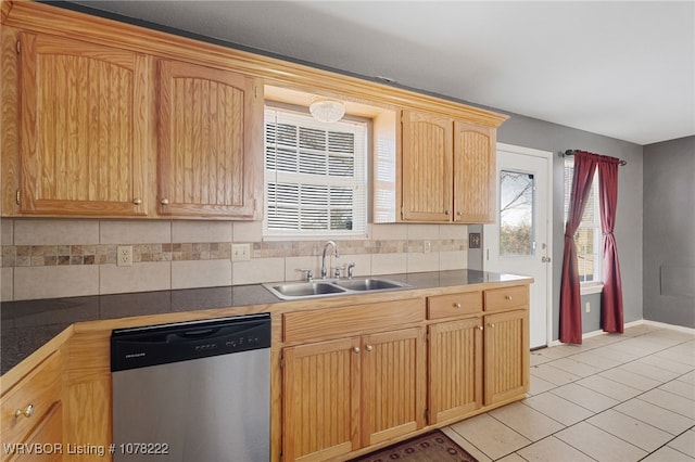 kitchen with light brown cabinetry, tasteful backsplash, stainless steel dishwasher, sink, and light tile patterned floors