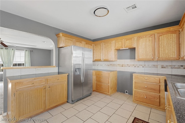 kitchen with light brown cabinets, sink, decorative backsplash, ceiling fan, and stainless steel fridge with ice dispenser